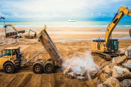 Smart construction equipment including electric excavators, autonomous loaders, and connected machinery at an infrastructure site, representing India’s growing and tech-driven CE industry.