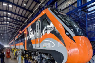 Vande Bharat Express train en route in a scenic mountainous region, marking its debut in Jammu & Kashmir with the Katra–Srinagar route.