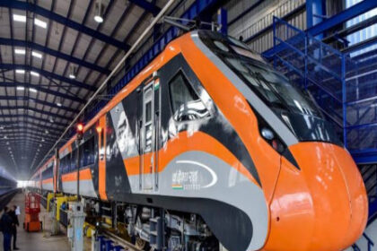 Vande Bharat Express train en route in a scenic mountainous region, marking its debut in Jammu & Kashmir with the Katra–Srinagar route.