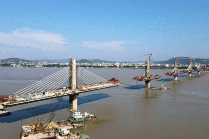 A nearly completed six-lane Brahmaputra bridge in Guwahati with final construction and finishing work in progress.
