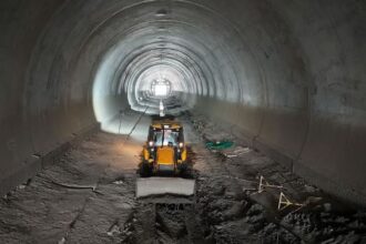 Tunnel construction work in India showing underground road and rail tunnels in mountainous terrain, marking 200 km infrastructure milestone