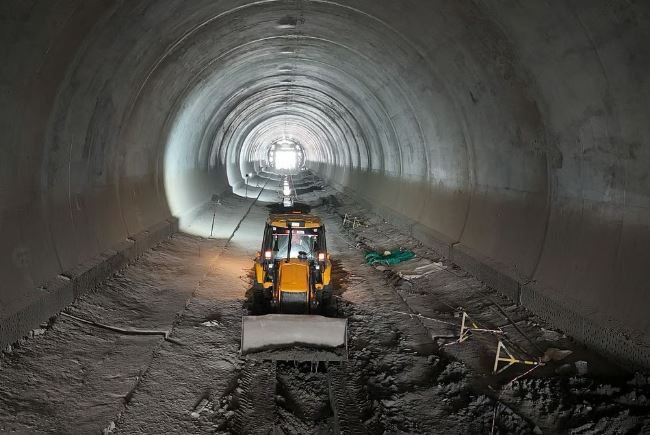 Tunnel construction work in India showing underground road and rail tunnels in mountainous terrain, marking 200 km infrastructure milestone