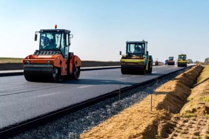 National highway construction site in India showing ongoing roadwork and heavy machinery, reflecting MoRTH’s projected execution of 9,000–9,500 km in FY2026-27 amid slower project awards.