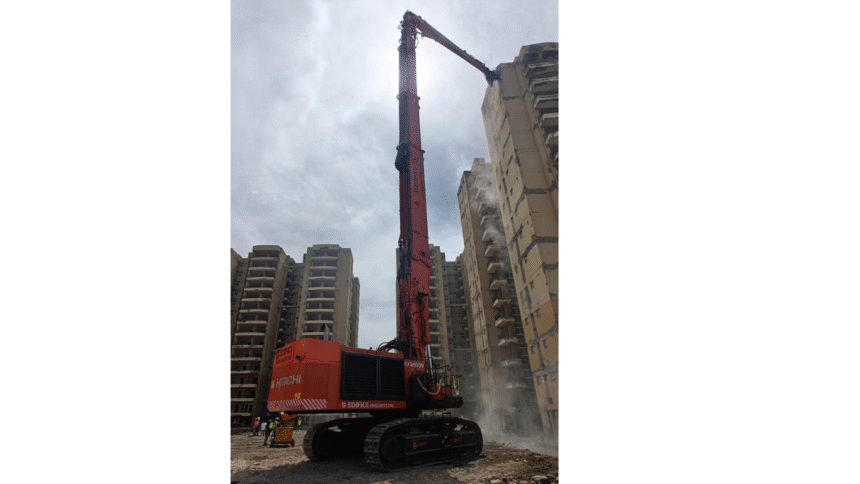 Tata Hitachi EX1200V excavator with high-reach demolition attachment operating on high-rise building in Haryana