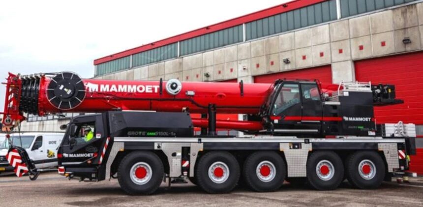 Manitowoc hybrid all-terrain crane with plug-in charging capability operating at construction site for low-emission lifting operations